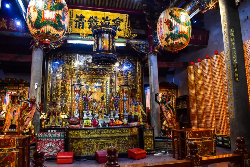 Un autel richement décoré à l'intérieur d'un temple chinois à  faire à Taipei présente des touches d'or, des lanternes de dragon, des statues, des offrandes, des bâtons d'encens et des tableaux de prières illuminés. 